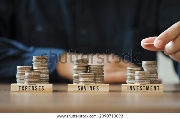 Businessmen or accountants are stacking coins to\
plan future financial account management. Income Management\
Concepts for Savings investment and\
expenses