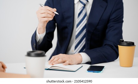Businessmen and businesswomen exchanging opinions. - Shutterstock ID 2105412590