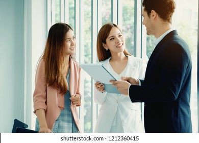 Businessmen are contracting with international team to expand their business the global market. In Asia, Europe and America. Work happily have a clear goal work. English is essential in communication.
