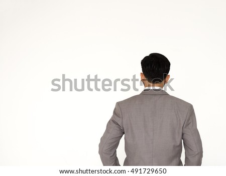 businessmen in darkgray suit from the back looking at something over white background.