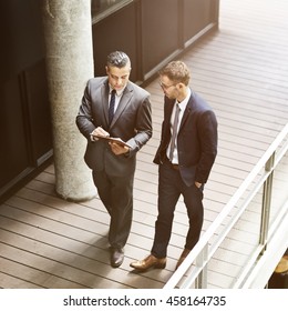 Businessmen Discussion Standing Clipboard Concept