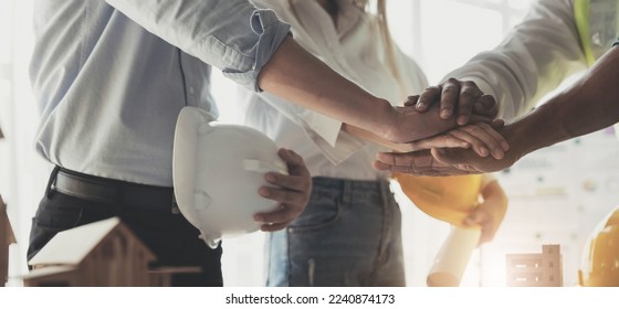 Businessmen and engineers join hands to build successful projects. Teamwork concept.

 - Powered by Shutterstock