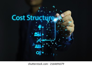 Businessmen or entrepreneurs use a pen to analyze a cost structure that includes factors such as production cost, staffing costs, maintenance costs, and advertising. - Shutterstock ID 2164696379