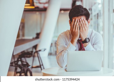 Businessmen feel stressed and tired sitting at his office with a laptop,mobbing concept - Shutterstock ID 1175394424