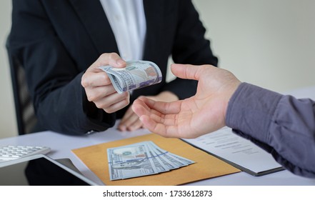 Businessmen give dollars to bribe employees in signing contracts to buy illegal land and real estate, Business fraud and social injustice, corruption and bribery concept. - Shutterstock ID 1733612873