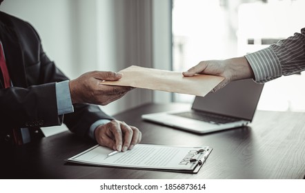 Businessmen give dollars to bribe employees in signing contracts to buy illegal land and real estate, Business fraud and social injustice, corruption and bribery concept. - Shutterstock ID 1856873614