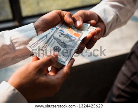 Businessmen give money to his partner, business concept.