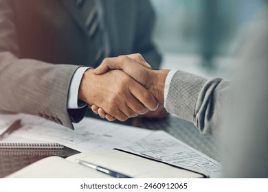 Businessmen, handshake and deal with paperwork, agreement and notebook in office for business. Male people, employees and colleagues in onboarding for partnership, negotiation and meeting in company - Powered by Shutterstock