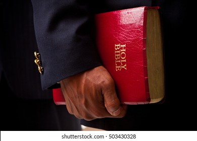 Businessmen Holding A Bible.