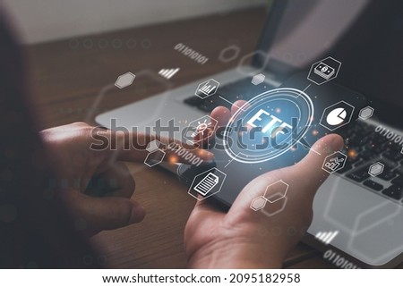 Businessmen holding a smartphone with icons of ETF Exchange traded fund stock market trading investment financial concept.