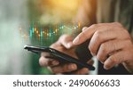 Businessmen investor think before buying stock market investment using smartphone to analyze trading data. trader is showing a growing virtual hologram stock on smartphone. Financial stock market.