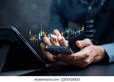 Businessmen investor think before buying stock market investment using smartphone to analyze trading data. investor analysis with stock exchange graph on screen. Financial stock market. - Shutterstock ID 2261926833