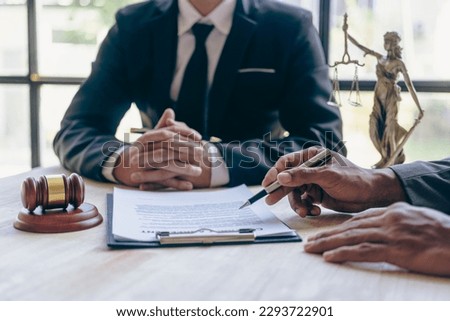 Businessmen and lawyers discuss contract documents, treaties of law, sign business contracts. Male consulting lawyers have team meetings with clients in the office.