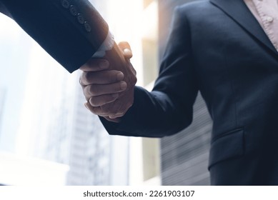 Businessmen making handshake in the city,  business etiquette, congratulation, merger and acquisition, business meeting and partnership concepts - Shutterstock ID 2261903107