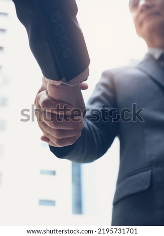 Businessmen making handshake in the city,  business etiquette, congratulation, merger and acquisition, business meeting and partnership concepts, vertical composition