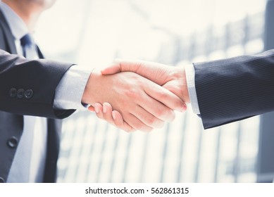 Businessmen making handshake - greeting, dealing, merger and acquisition concepts