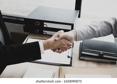 Businessmen Making Handshake In The Office Room. Business Etiquette, Congratulation, Greeting, And Dealing.