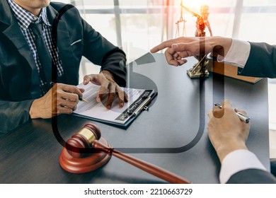 Businessmen And Male Lawyers Or Judges Who Have Team Meetings With Clients. The Concept Of Legal Service Of Injustice With Hammers And Scales Next To It.