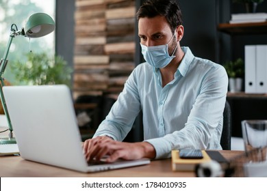 Businessmen With Medical Mask Working In Office. Businessman At His Work Place With Medical Mask. Covid-19 Concept.