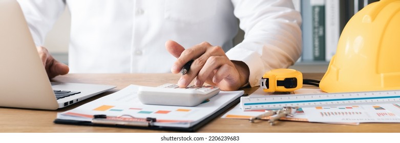 Businessmen are planning budgets for construction projects, analyzing company financial statements, managing global construction project costs.