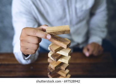 Businessmen Are Playing Jenga Game. Concept Of Business Planning Is Good, And Despite The Risk Is No Problem.