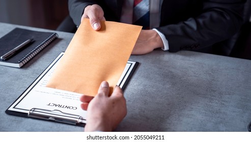 Businessmen or politicians agree to accept bribes given in envelopes. To do illegal business, corruption in the contracting business, corruption concept and bribery. - Shutterstock ID 2055049211