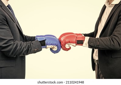 Businessmen or politicians cropped view in suits wear boxing gloves ready to fight, opposition