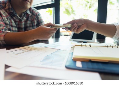 Businessmen are receiving dividends from investments. - Shutterstock ID 1008916330