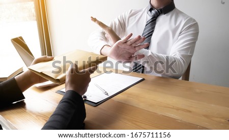 Businessmen refusing accept bribes at the office, Bribery and corruption concept.