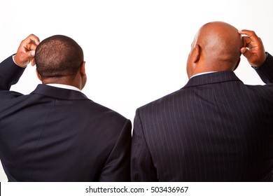 Businessmen scratching their heads.  Blank copy space. - Powered by Shutterstock