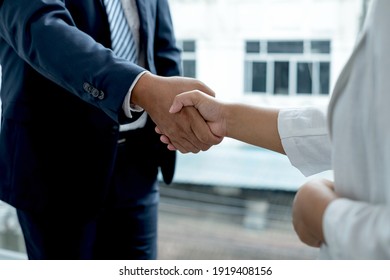 The businessmen shake hands after the meeting was successful and agreed upon. - Powered by Shutterstock