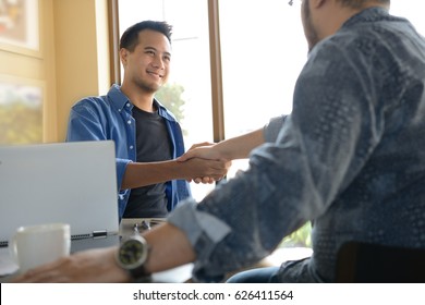 Businessmen Shaking Hands For Business Agreement In Office