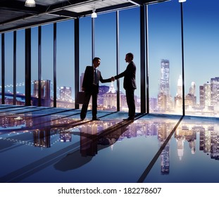 Businessmen Shaking Hands With City View