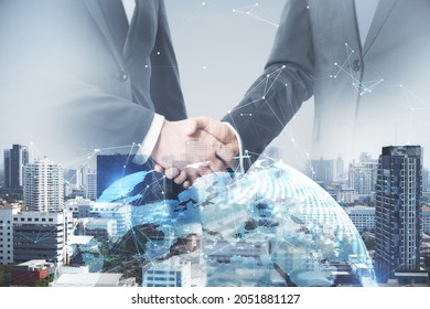 Businessmen shaking hands on bright white city background with globe and polygonal connections. Team work and success concept. Double exposure