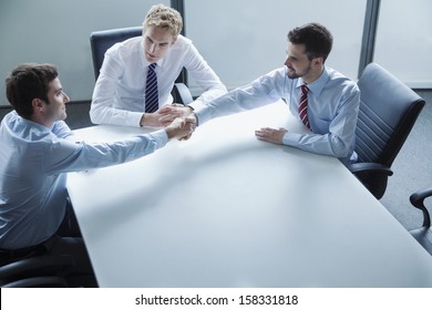 Businessmen Shaking Hands Over The Table In The Office