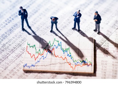Businessmen are skeptical looking at stock market charts. - Shutterstock ID 796394800