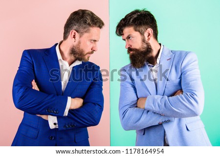 Businessmen stylish appearance jacket pink blue background. Tense face expression competitors. Business competition and confrontation. Business partners competitors in suits with tense bearded faces.