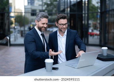 Businessmen trading online outdoor. Research and finance. Businessmen investor working with laptop analyzing stock market trading. Investment planning. American business men. Stock business trading - Powered by Shutterstock