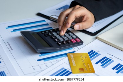 Businessmen Use A Calculator To Calculate Income And Expenses In Order To Manage Budgets To Pay Off Credit Card Debt.