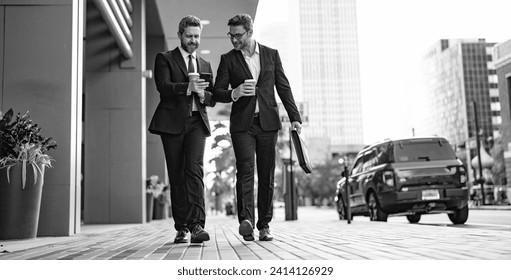 businessmen walk with phone in suit, copy space advertisement. photo of businessmen walk