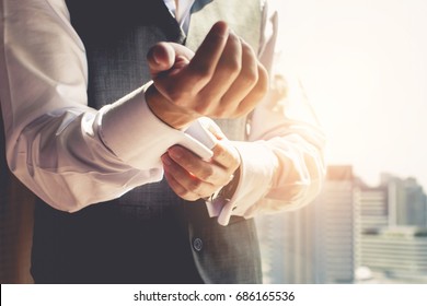 Businessmen Are Wearing Suit And Fixing His Cufflinks