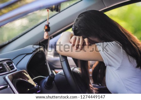 Businessmen who are driving a car along the road have a headache because of the accumulated stress from doing unsuccessful business and have to take the effort to revive the business by themselves.