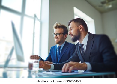 Businessmen working with computer in team