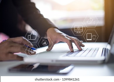 Businessmen working on digital marketing on a virtual screen with modern mobile phones and computers - Shutterstock ID 1399841261