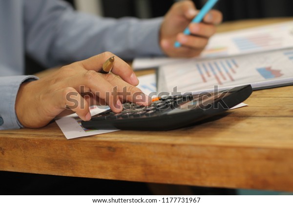 
Businessmen are working on financial
calculations using mobile phones, smartphones, computers, and
calculators on wooden
floors.