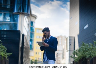 Businessmna Is Having A Second Look At His Plans And Ideas On His Tablet While Talking On His Phone