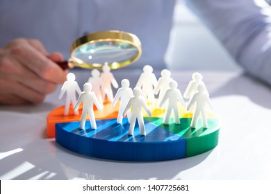 Businesspeople Analyzing Market Segment Using Magnifying Glass - Shutterstock ID 1407725681