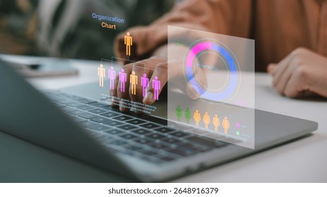 Businesspeople analyzing a virtual organization chart and infographic on a laptop, touching the digital interface, with a data analysis concept and HR technology.