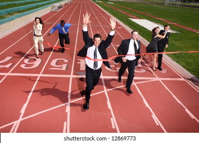 Businesspeople crossing the finish line - Powered by Shutterstock