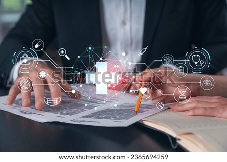 Businesspeople in formal wear taking notes signing contract at office workplace. Concept of important working moments, document sign, working process, concentration. Hands shot. Medical hologram